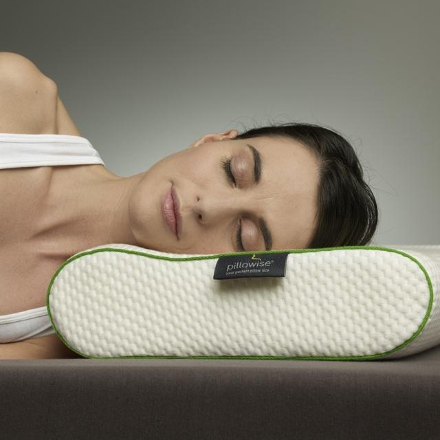 Woman sleeping on orthopedic neck pillow